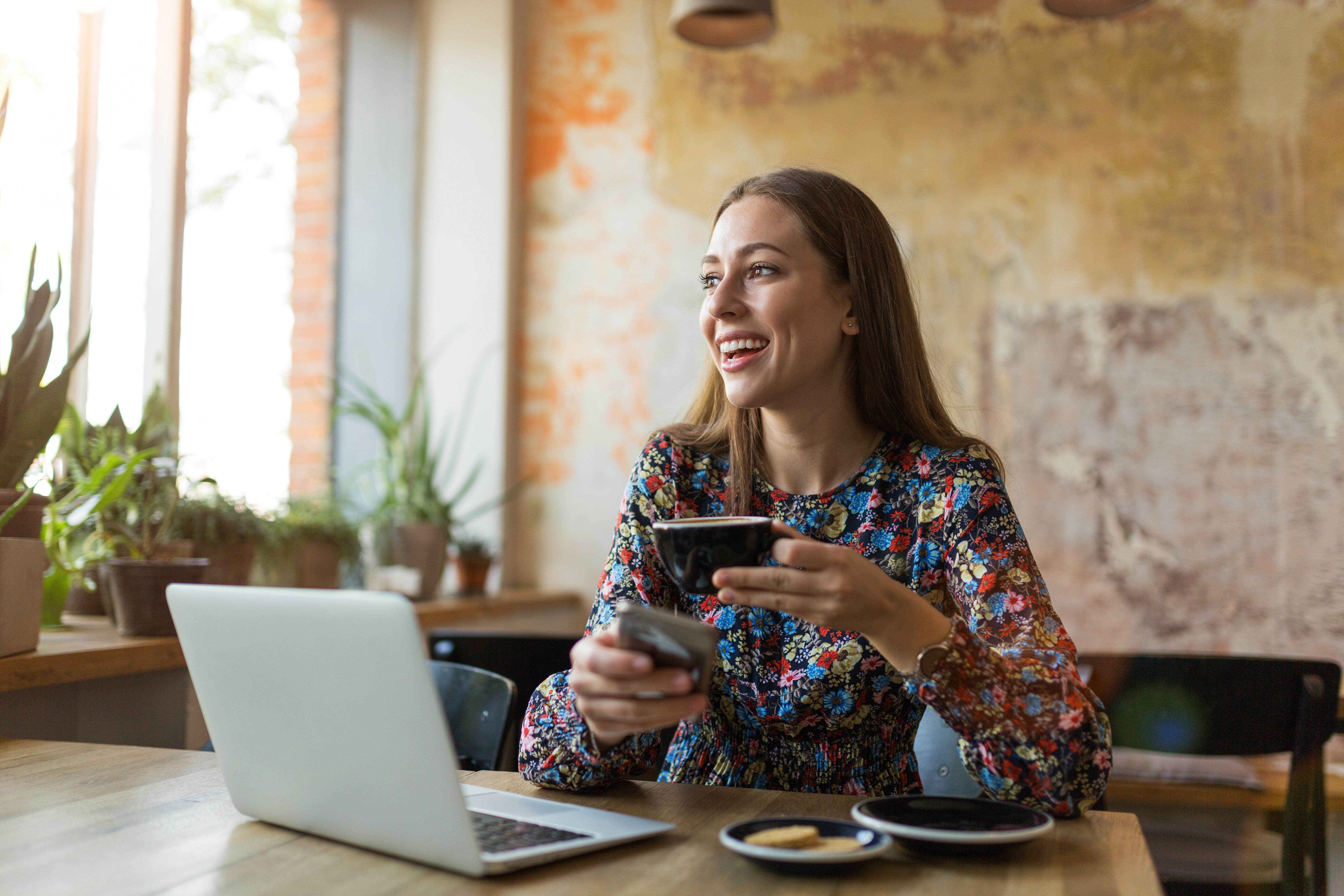 A woman makes an online purchase using her cash back credit card.