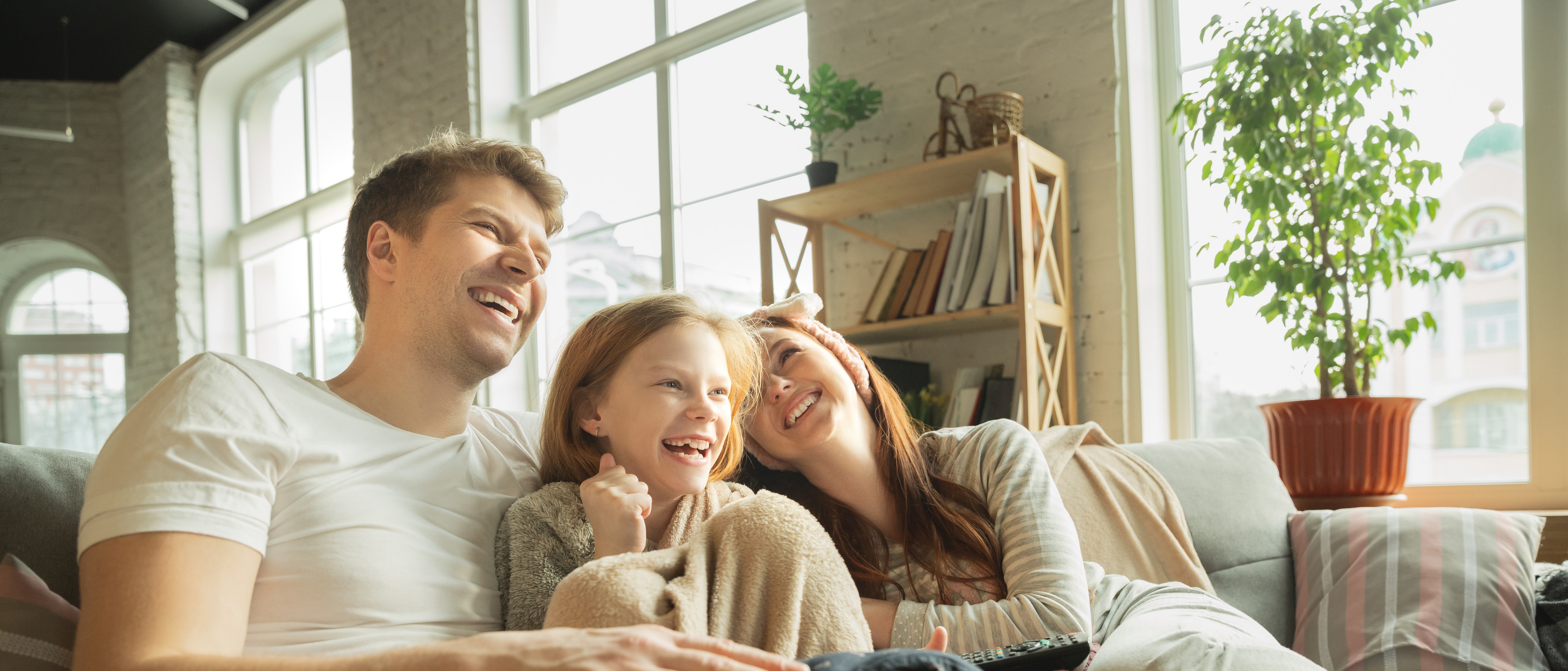 A young family enjoys time at home in a new house financed with a conventional mortgage.