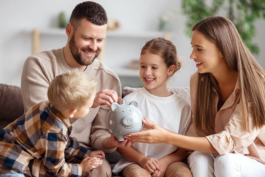 A family puts money into a piggy bank before opening a credit union certificate of deposit.