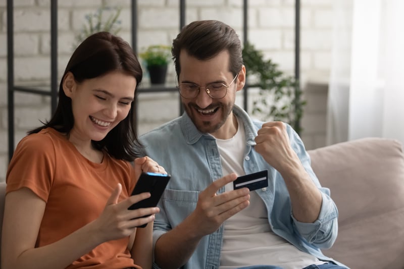 A couple celebrates reaching a milestone balance in their Money Market Account.