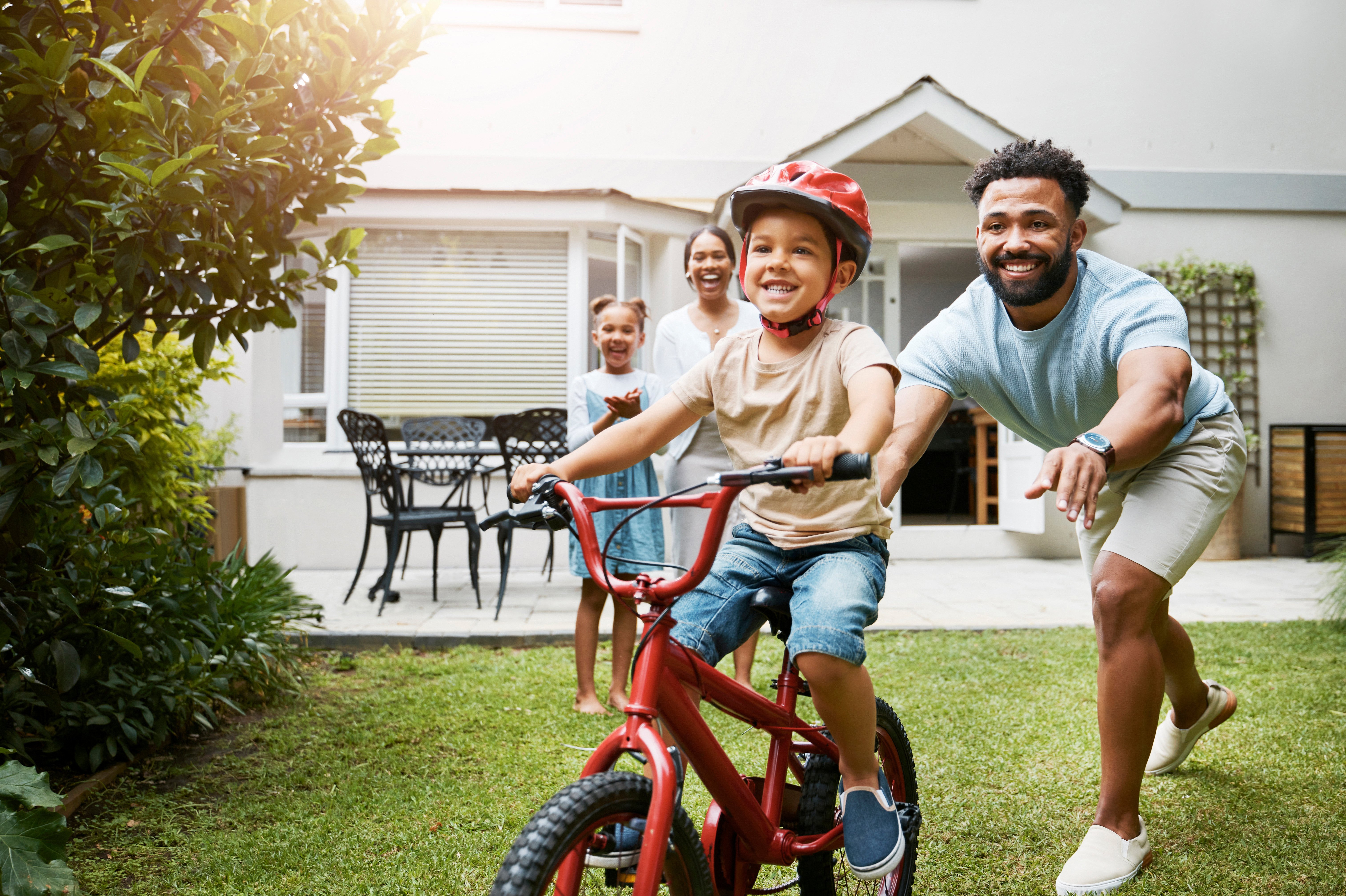 A proud family outside their home following an FHA Streamlined Refinance through Wasatch Peaks Credit Union.