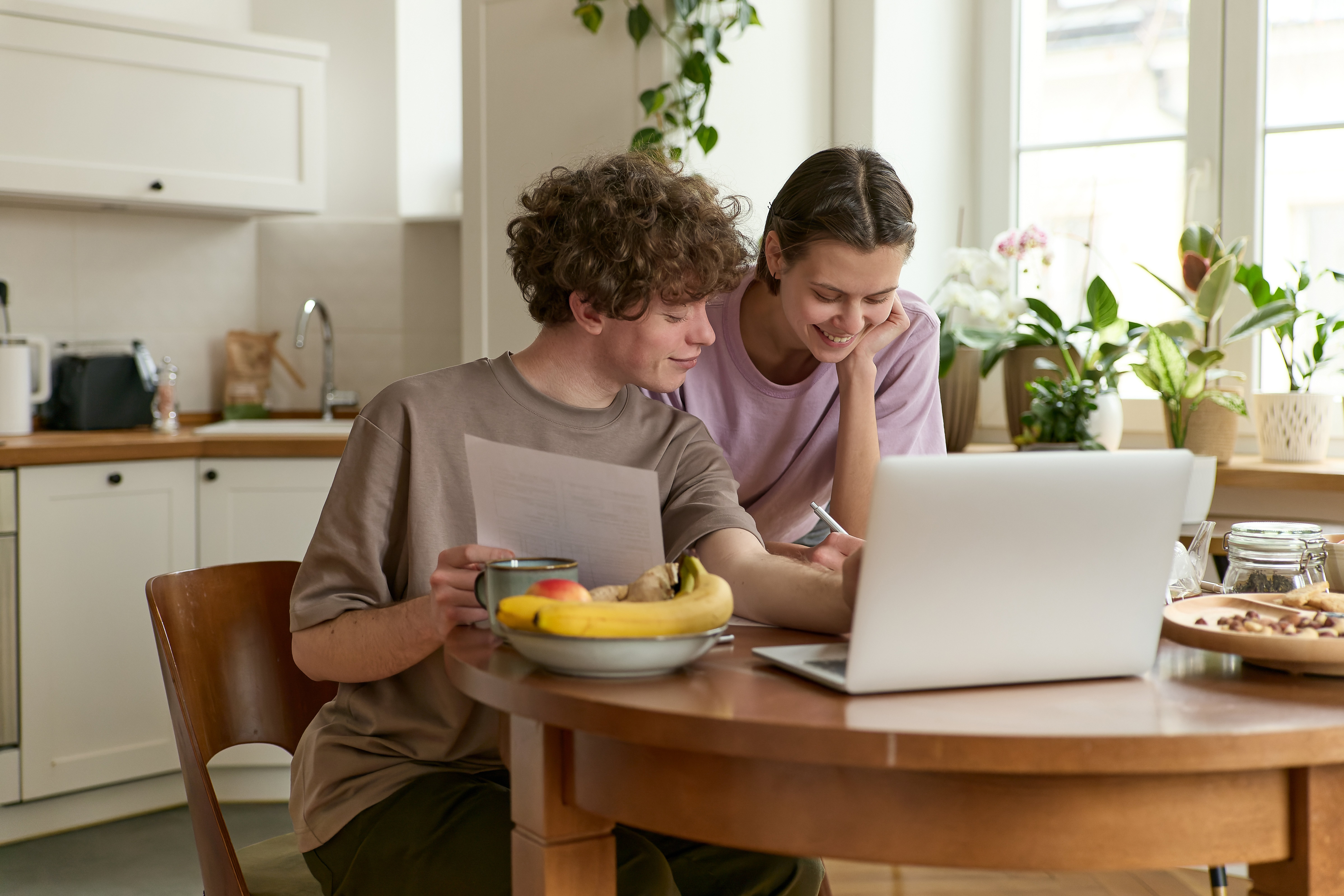 Couple researching a Certificate Secured Loan on their laptop at home.