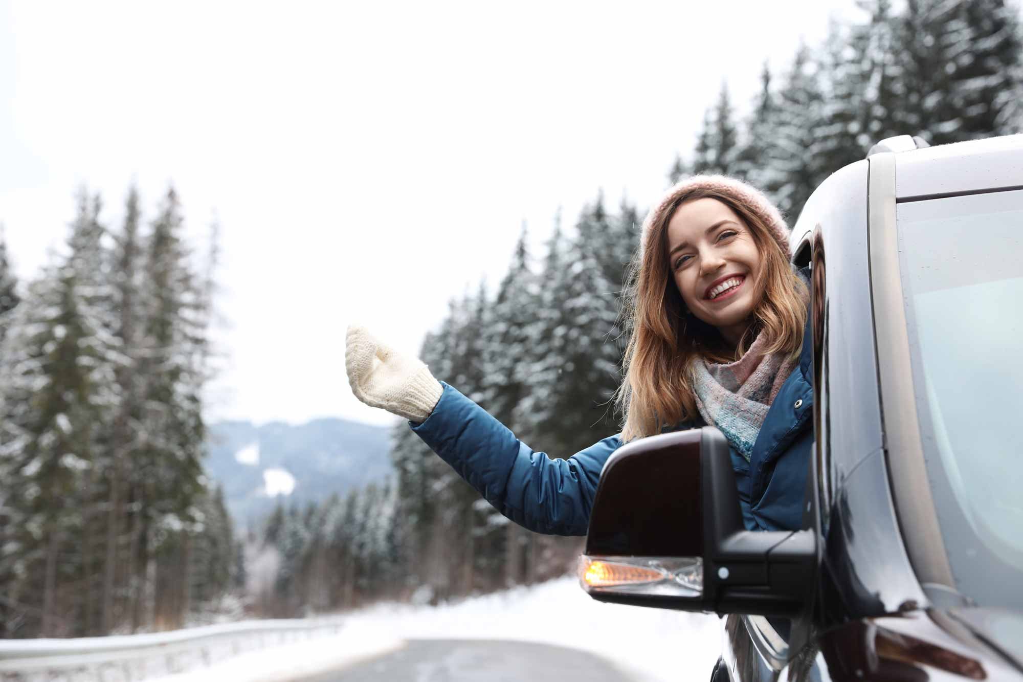 Smiling man next to vehicle purchased with a Wasatch Peaks auto loan.