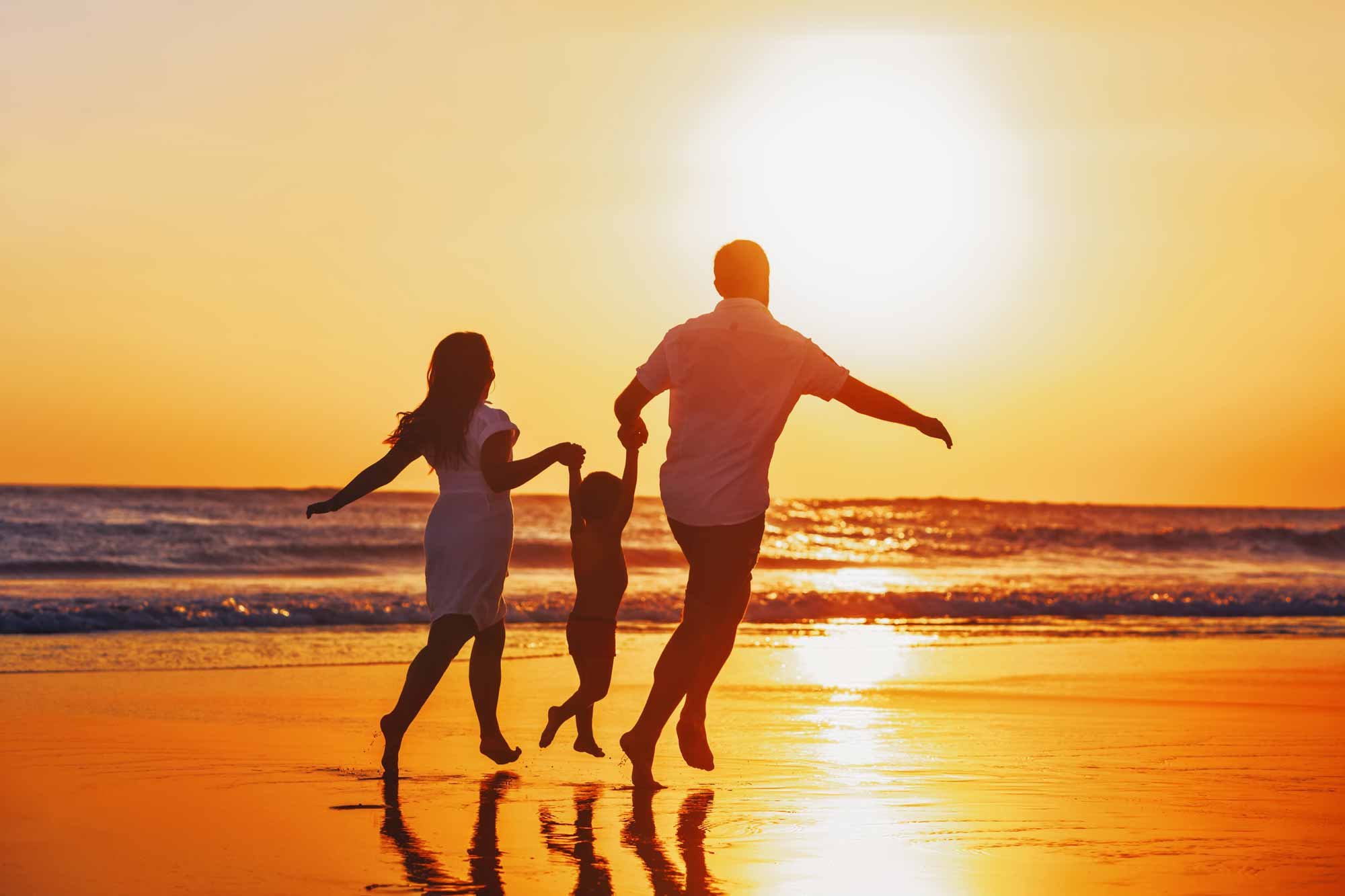 Family enjoying sunny beach vacation with discount from Benefits Plus, a checking account benefit