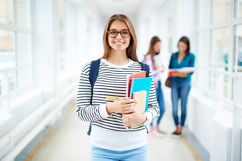 College student standing in hallway