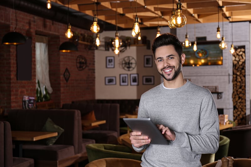 Business-owner-with-table-at-his-cafe