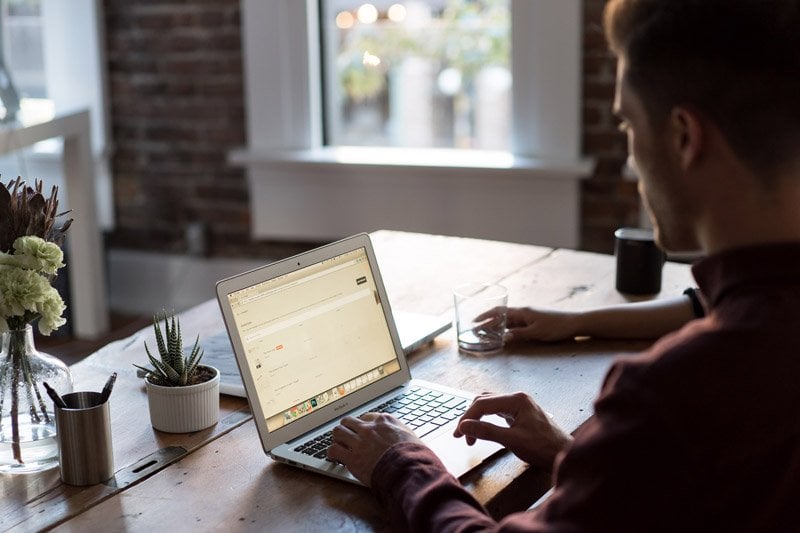 Man typing on laptop computer