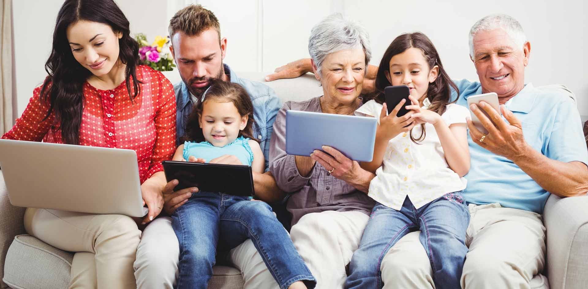 Multi-generational family sitting and interacting together on a variety of devices
