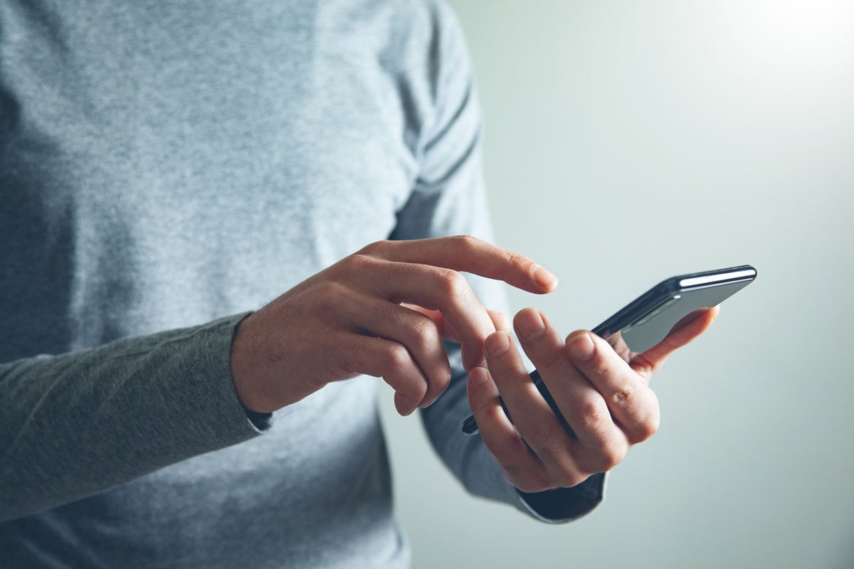 Person Holding Cell Phone