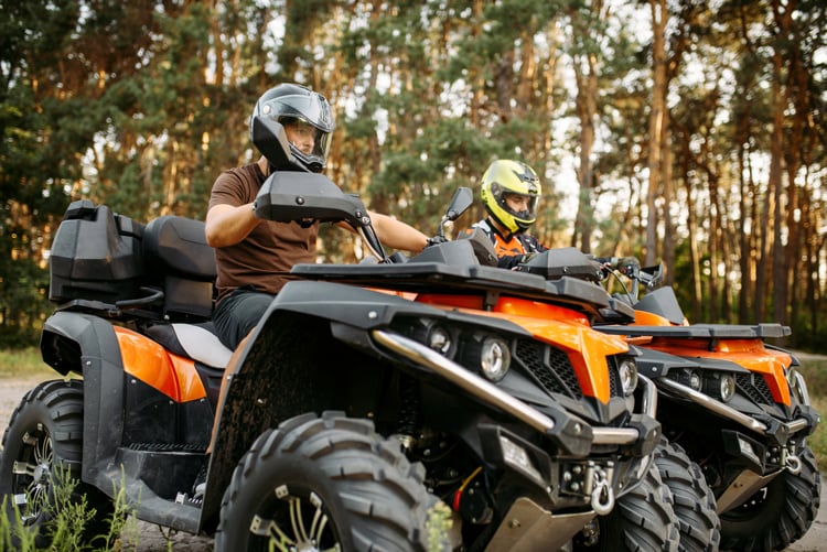 Two ATVs riding next to each other