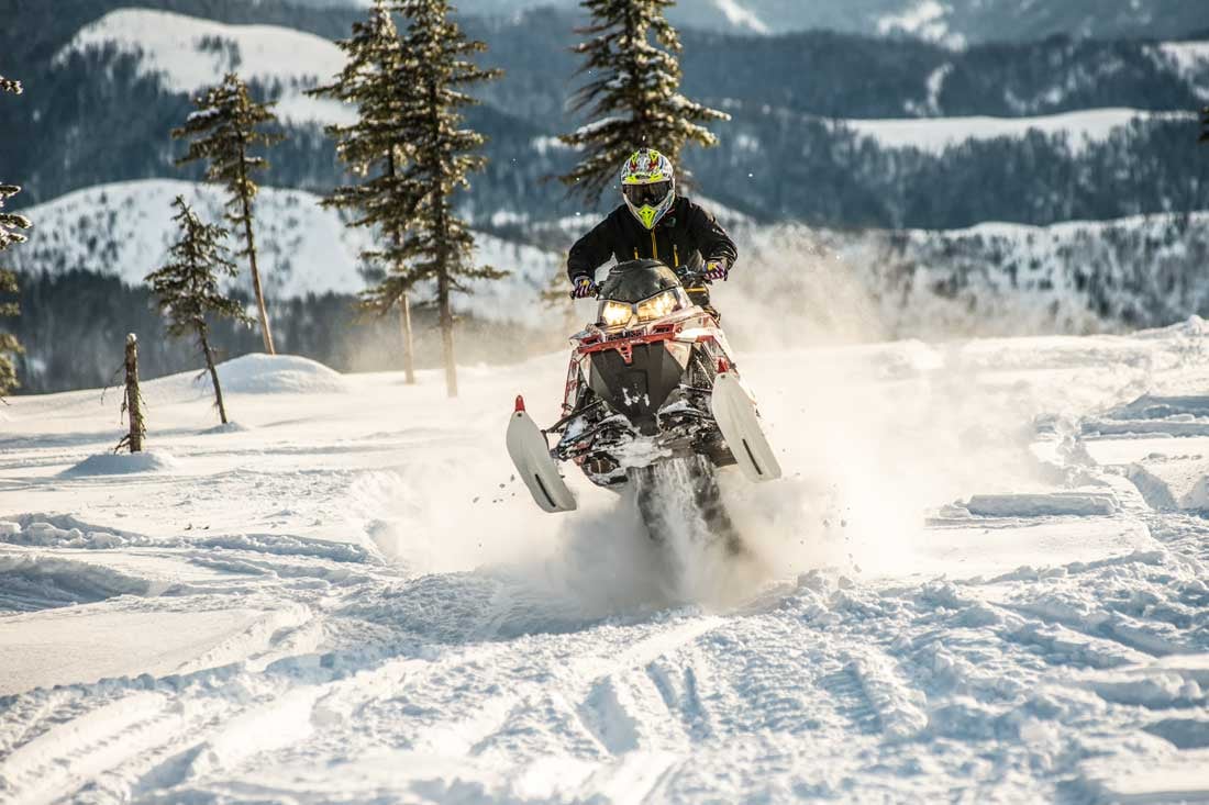 snowmobile jumping in snow