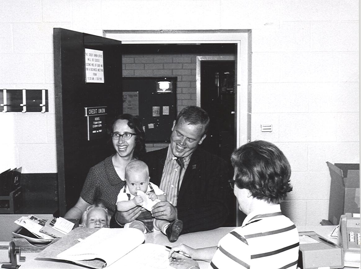 Old photo of a young family visiting the credit union