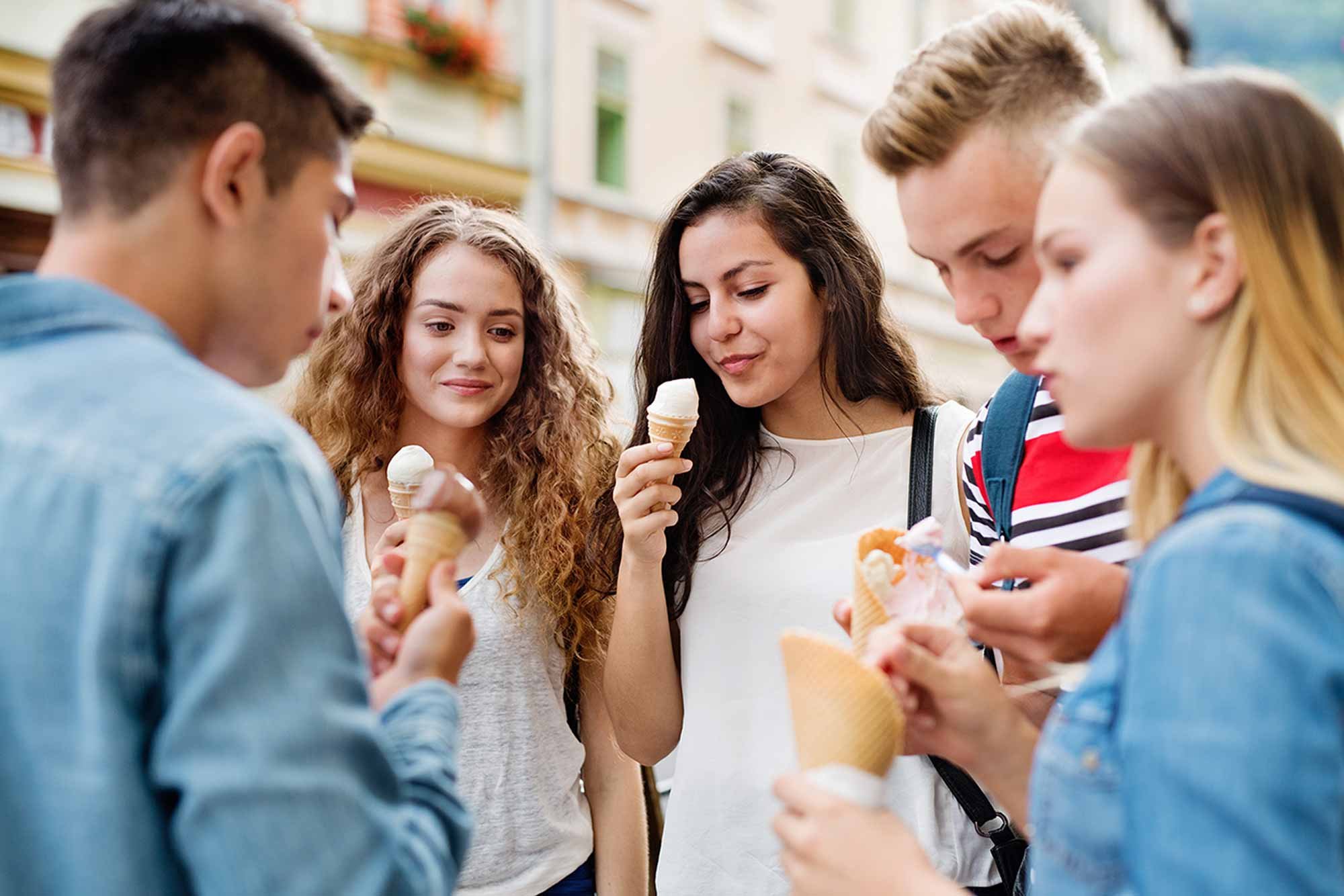Group of teens eating ice cream purchased using youth checking account.