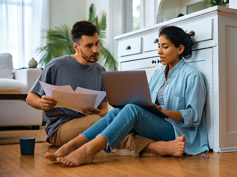 A couple going over the documents they need to apply for a first-time homebuyer grant.
