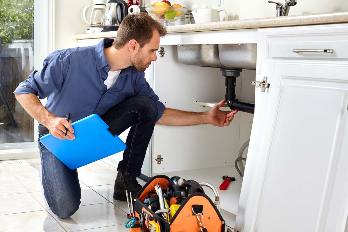 Plumber looking at sink