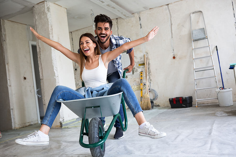 A couple enjoy making home improvements after considering a HELOC vs refinance.