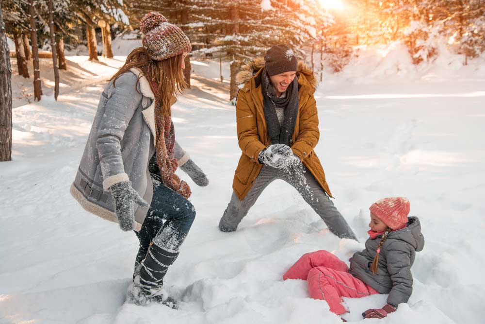 Family playing in the snow