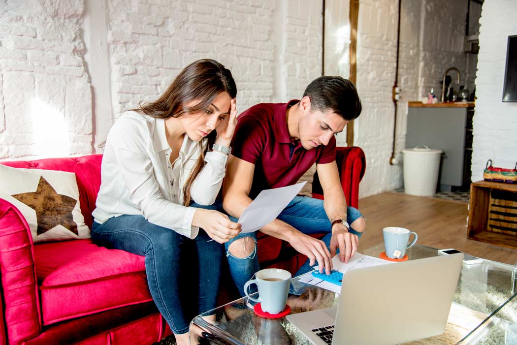 Stressed couple looking at bills