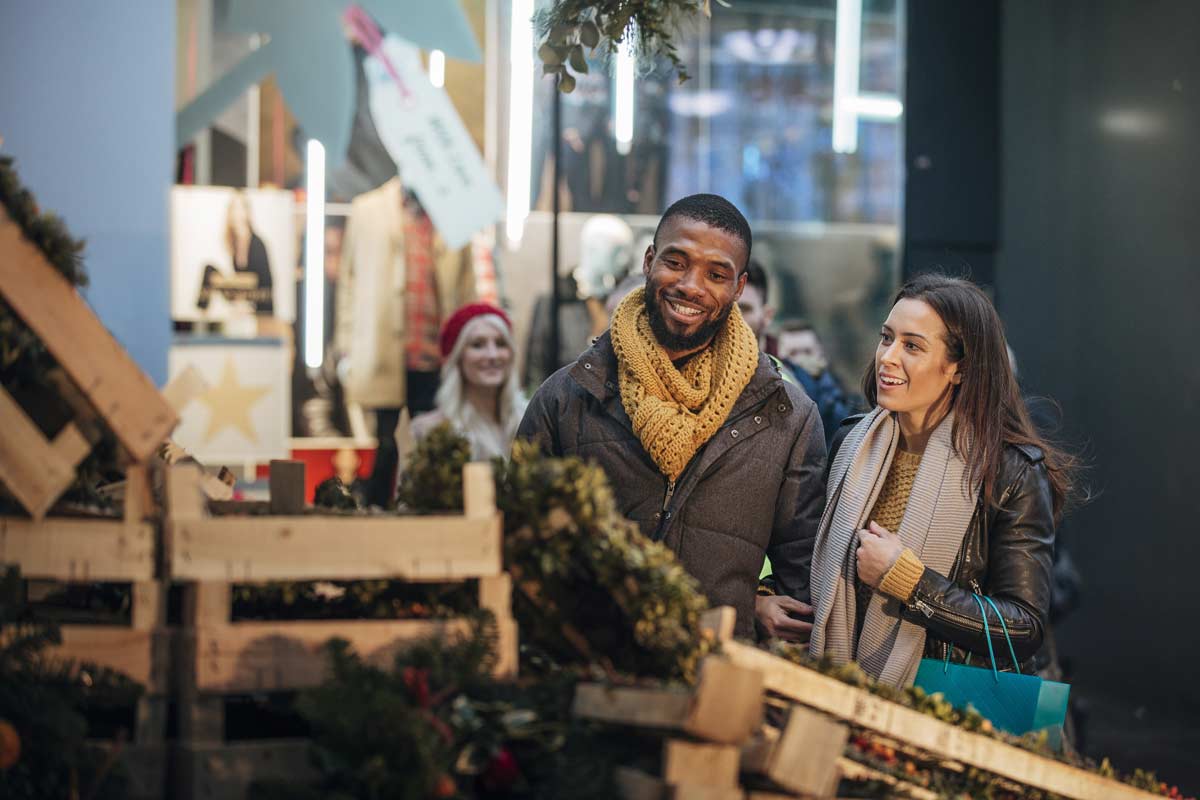 Couple looking at wreaths in a booth