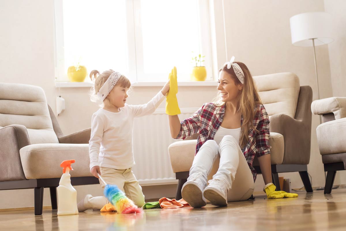 Mom and daughter high fiving after cleaning