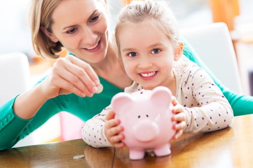 Mom and daughter with piggy bank