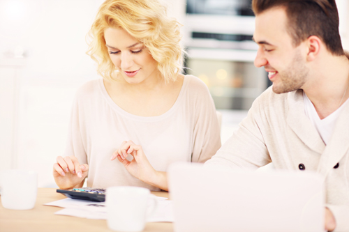 Couple using calculator