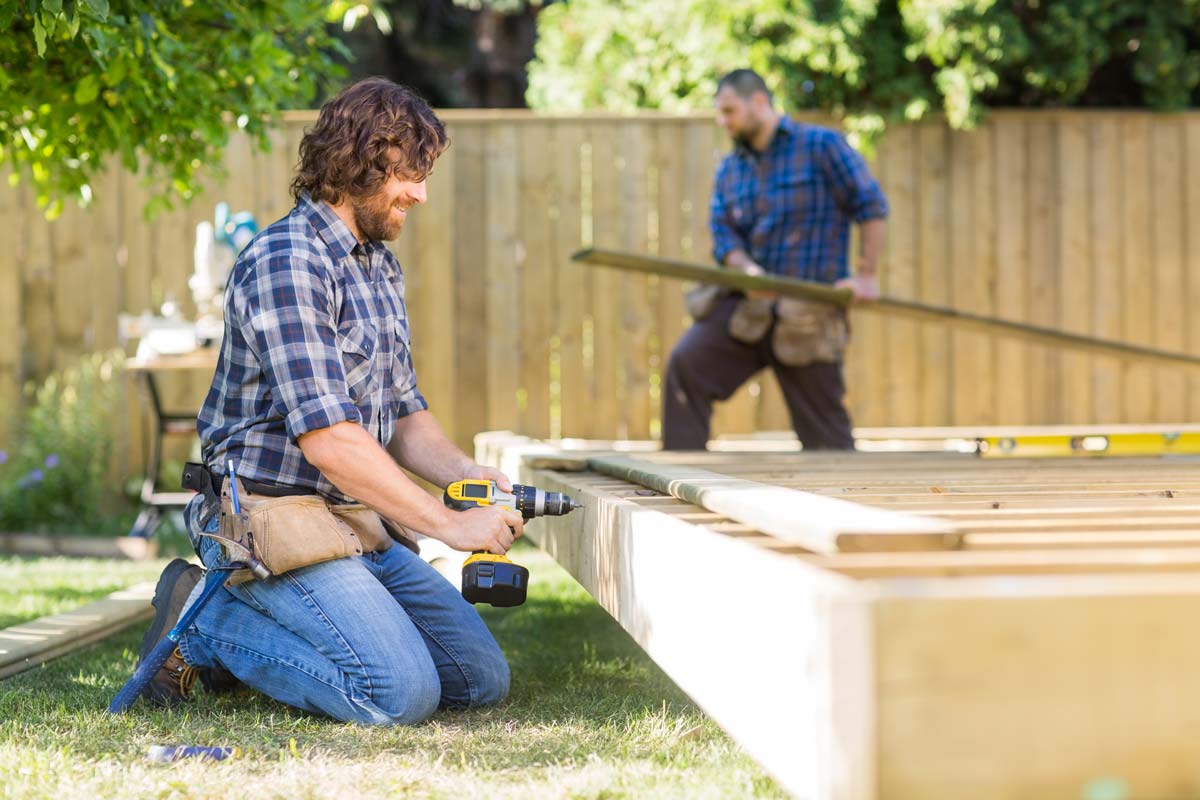 Two men building a wooden structure