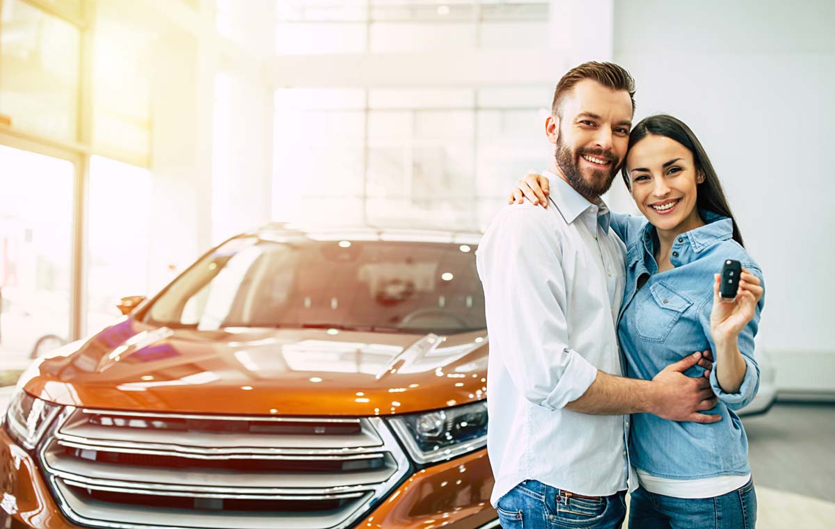 Couple smiling with car purchase