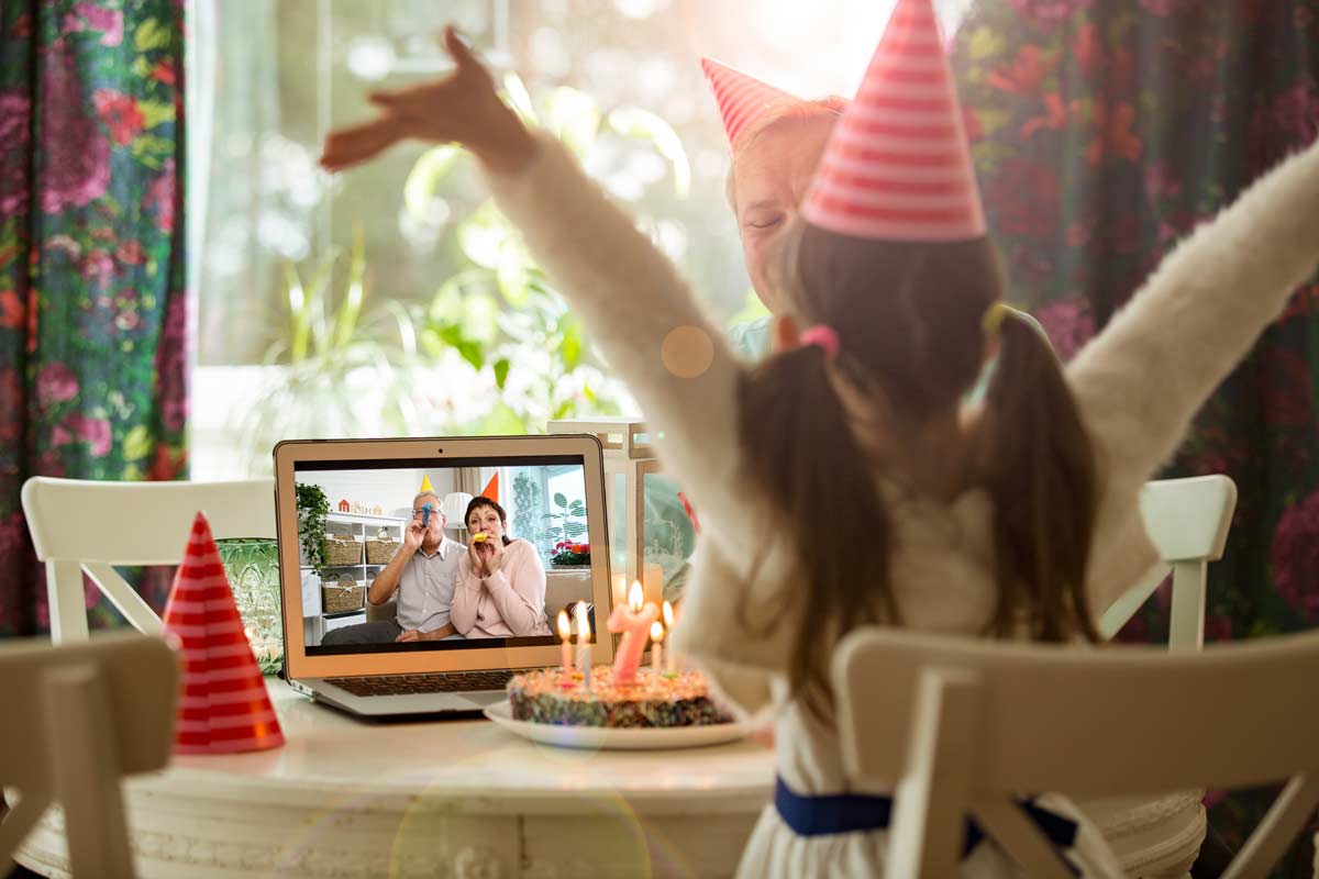 Little girl celebrating birthday with grandparents on video chat