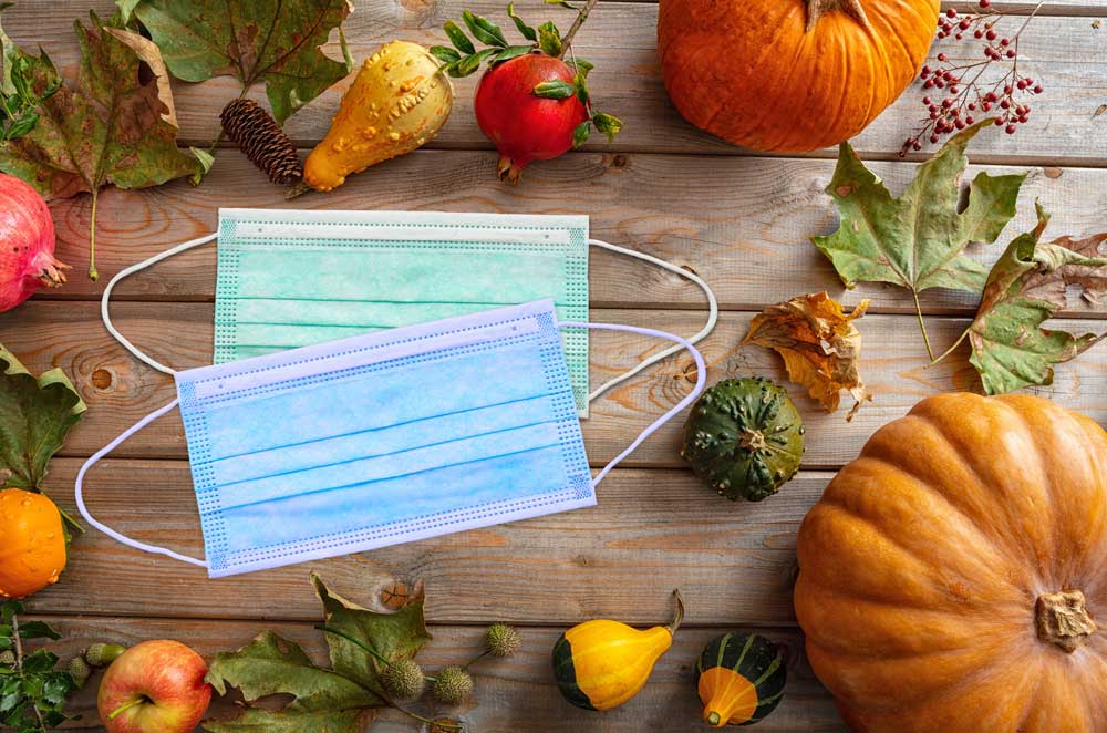 Masks, pumpkins, and fall foods on table