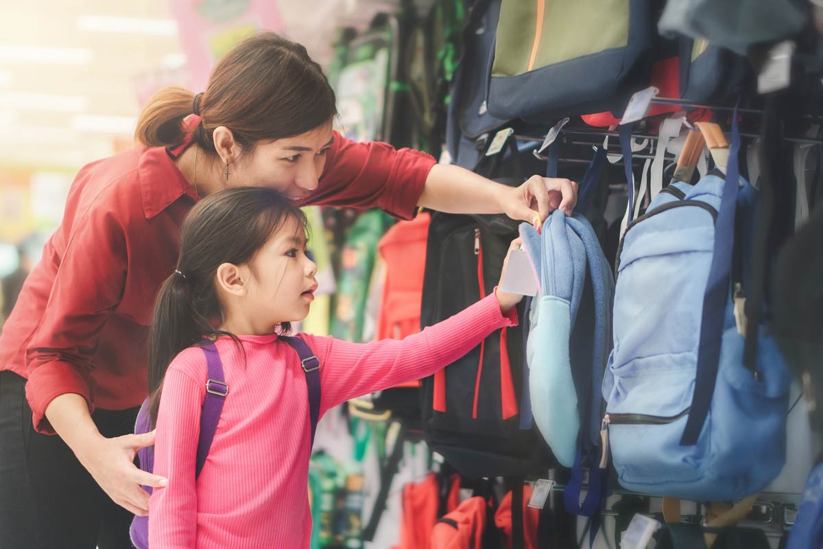 Mom and daughter shopping for backpacks