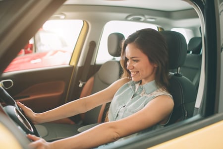 woman smiling in her new car