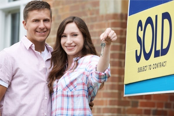 Couple holding keys to new house