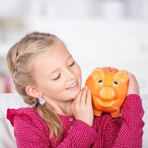 Girl holding piggy bank