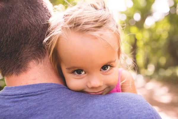 Dad holding daughter 