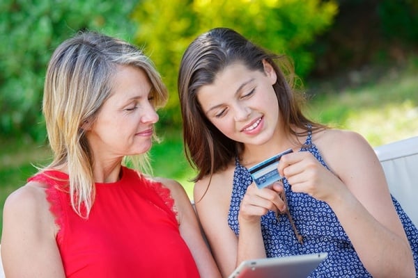 Mom with daughter holding a debit card