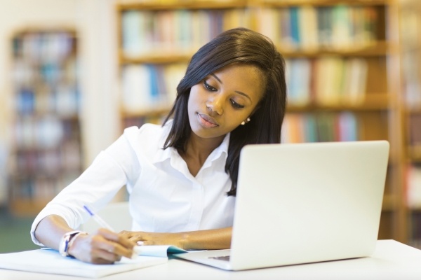 Young woman at the library with computer