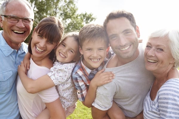 Grandparents, parents and kids smiling