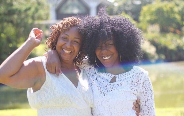 Mom and daughter smiling