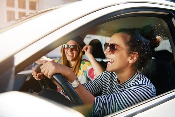 Young adults riding car