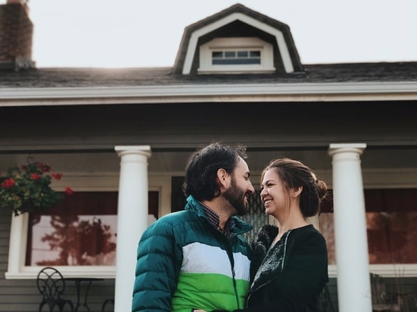 Couple in front of house