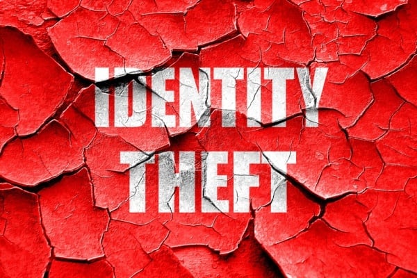 Identity Theft spelled on red broken background