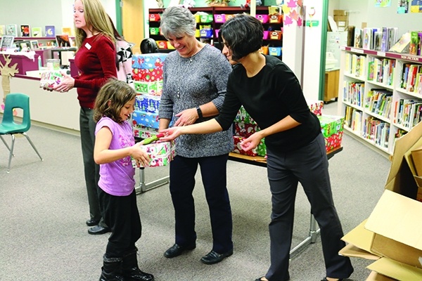 Passing out shoes and a stocking to a little girl