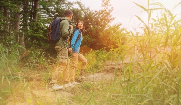 Couple with backpacks on a trail