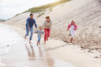 Family running by the beach