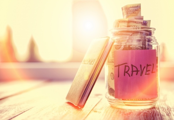Money in a jar labeled travel