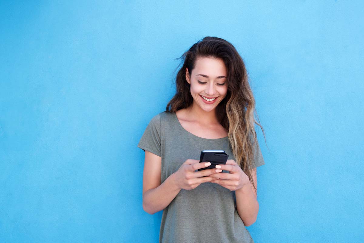 Young adult typing on her phone