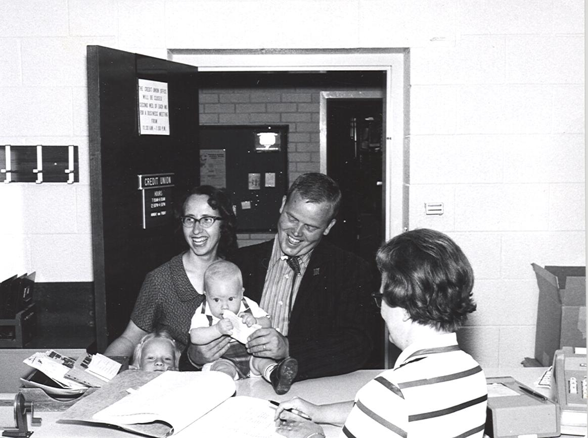 Black and white picture of family in old credit union