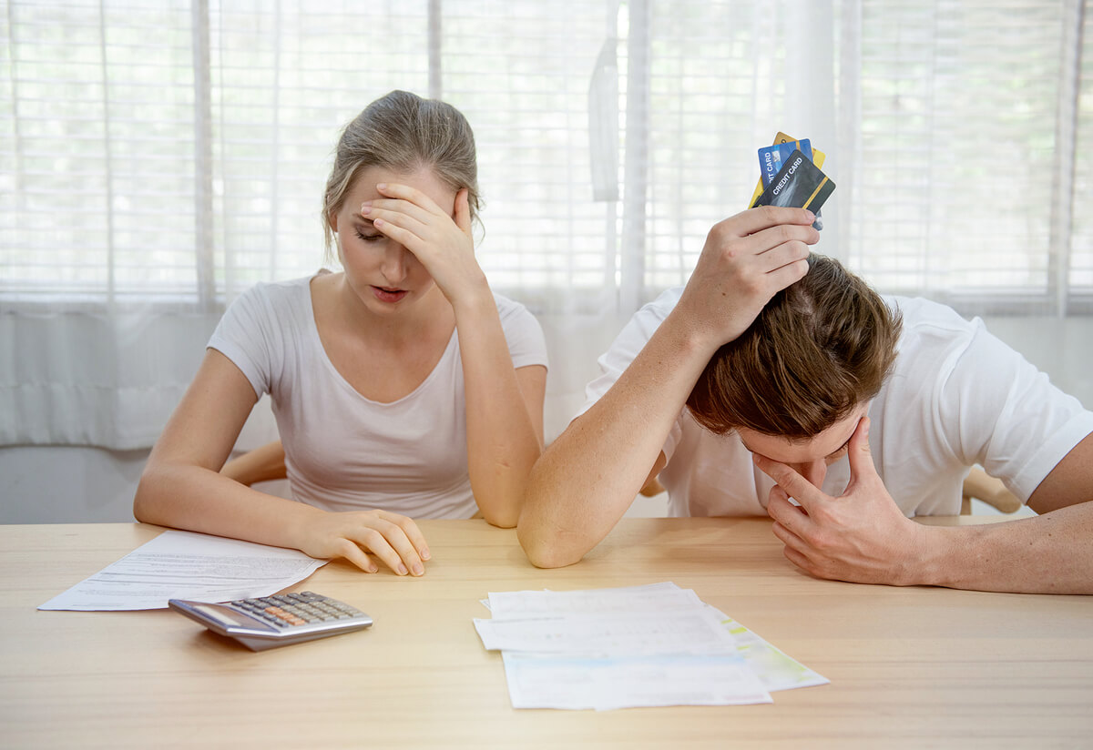 Stressed couple looking at credit card statements