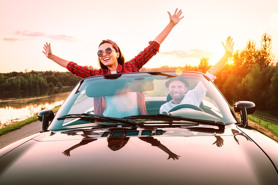 Couple driving in a convertible